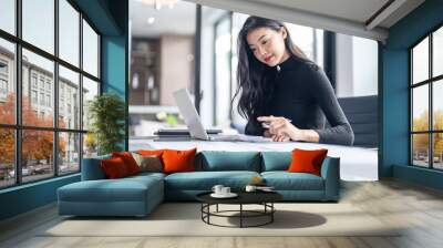 Beautiful confident asian business woman working with laptop Hands typing  keyboard. Professional investor working new start up project. business planning in office. Technology business Wall mural